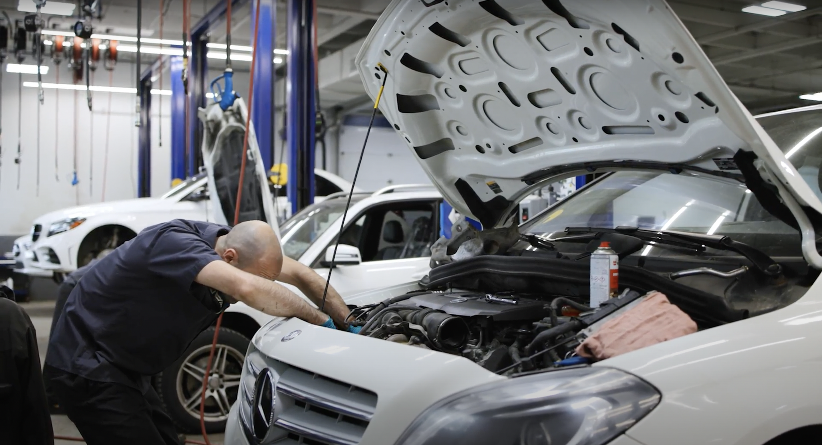 Technician working on a car in the service bay