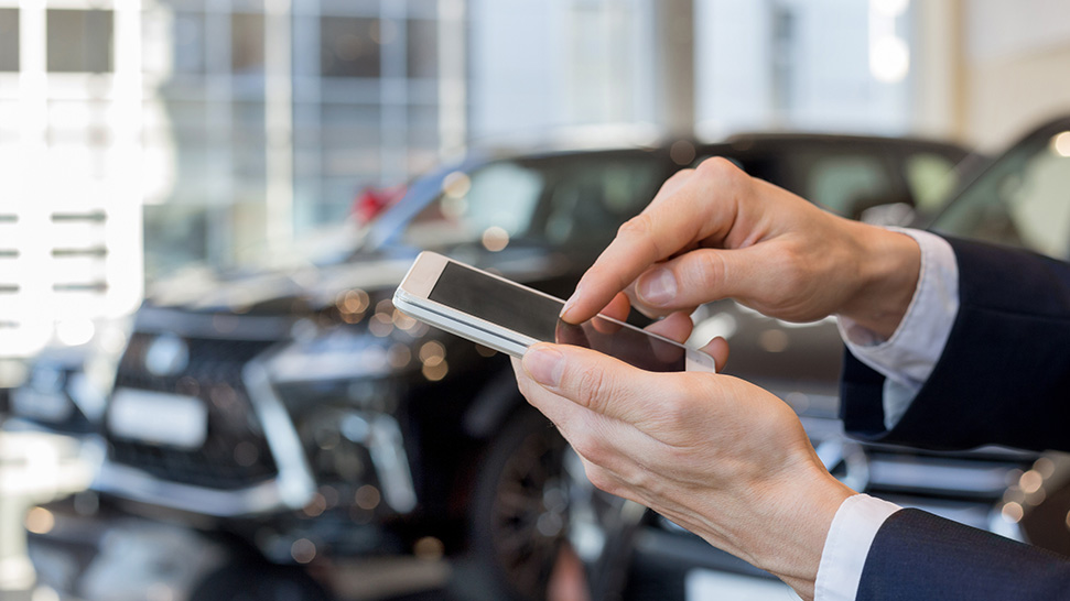 Someone reading a text message in a dealership